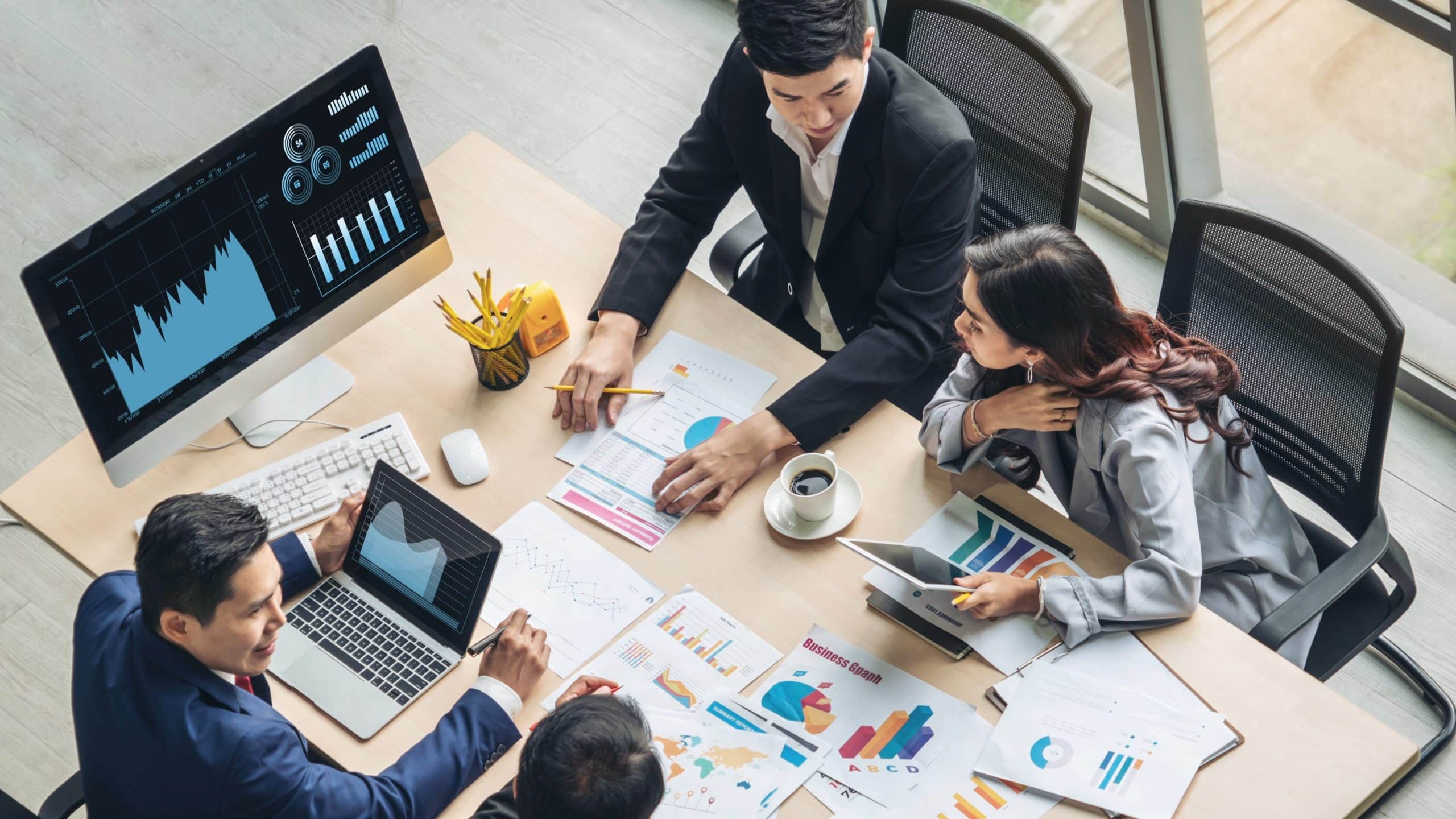 Businessmen analyzing data on computer 