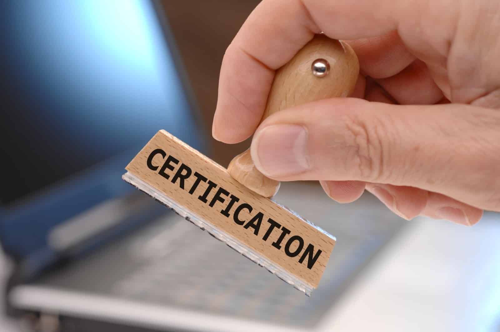 Man holding certification stamp