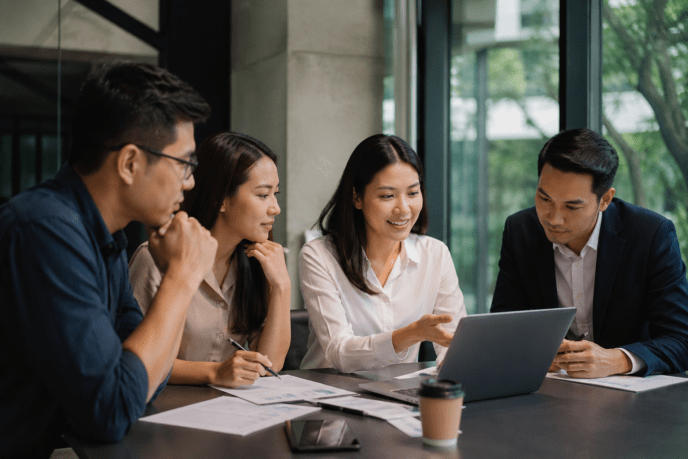 Group collaborating over a laptop