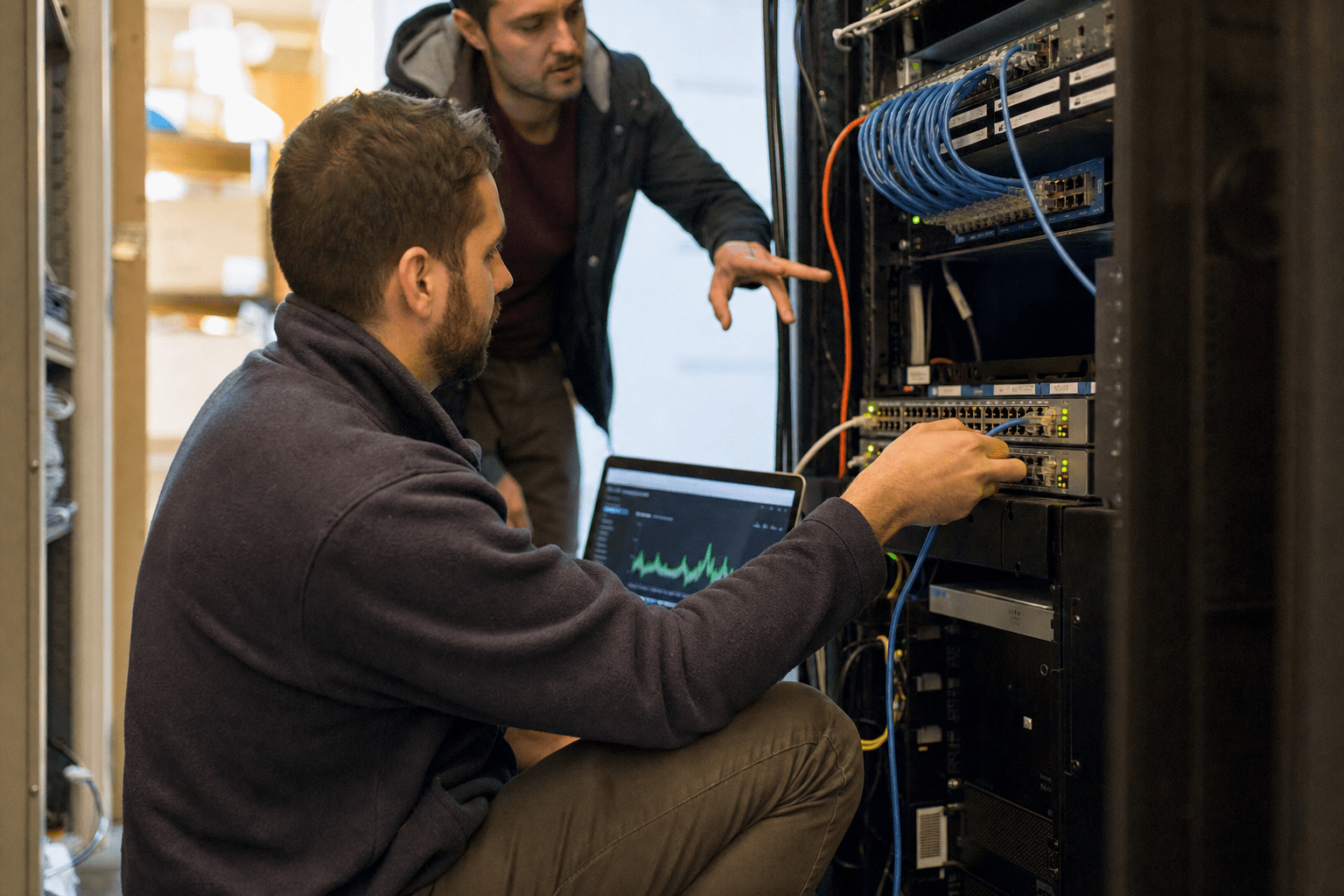 How to Diagnose and Fix Slow Business Network Performance 1 Technician diagnosing slow business network performance at server rack